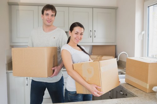 Professional movers loading household items into a removal van